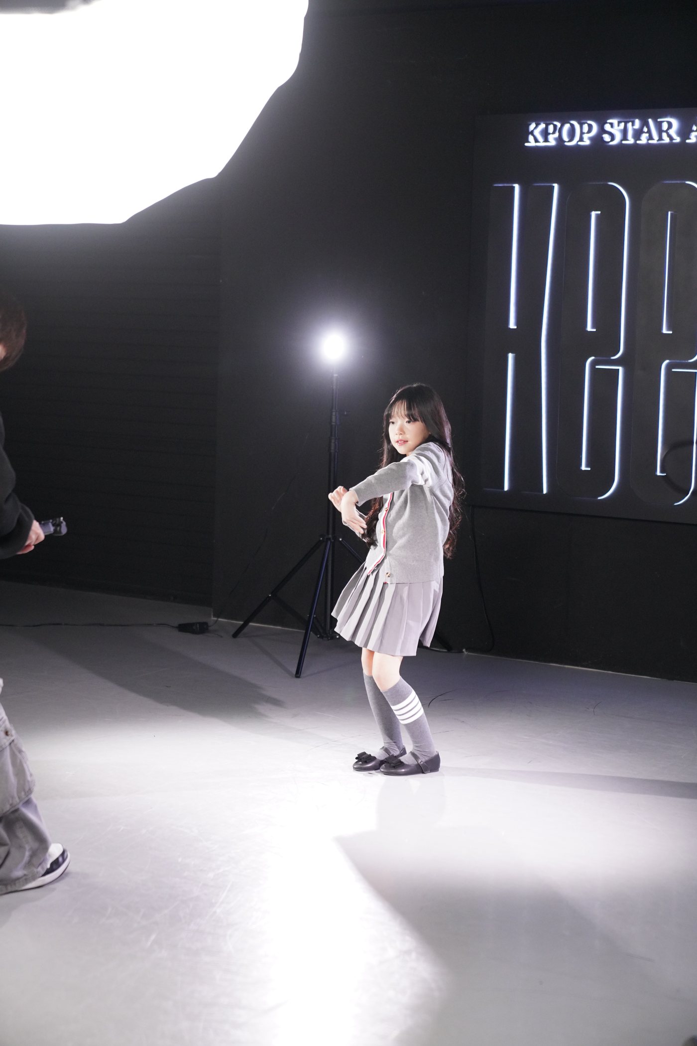 Keens Seoul studio — student in a coached dance session with lights and studio signage